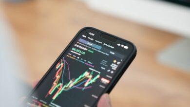 a person holding a cell phone in their hand