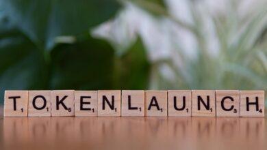 A wooden block spelling out the word tokenlaunch
