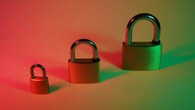 two brown padlock on pink surface