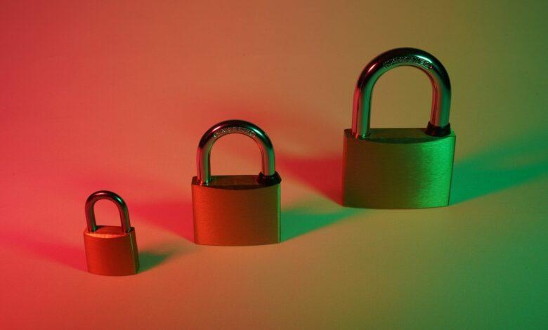 two brown padlock on pink surface